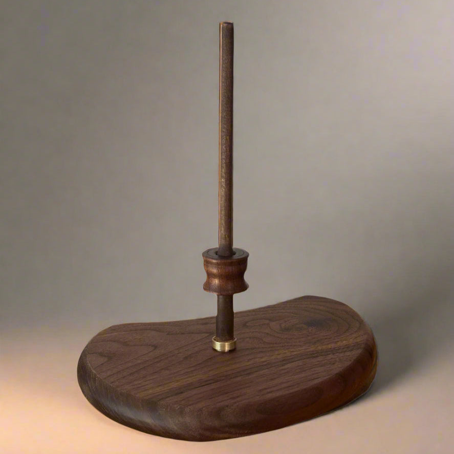 wood & Winds piccolo stand in solid walnut on a plain background